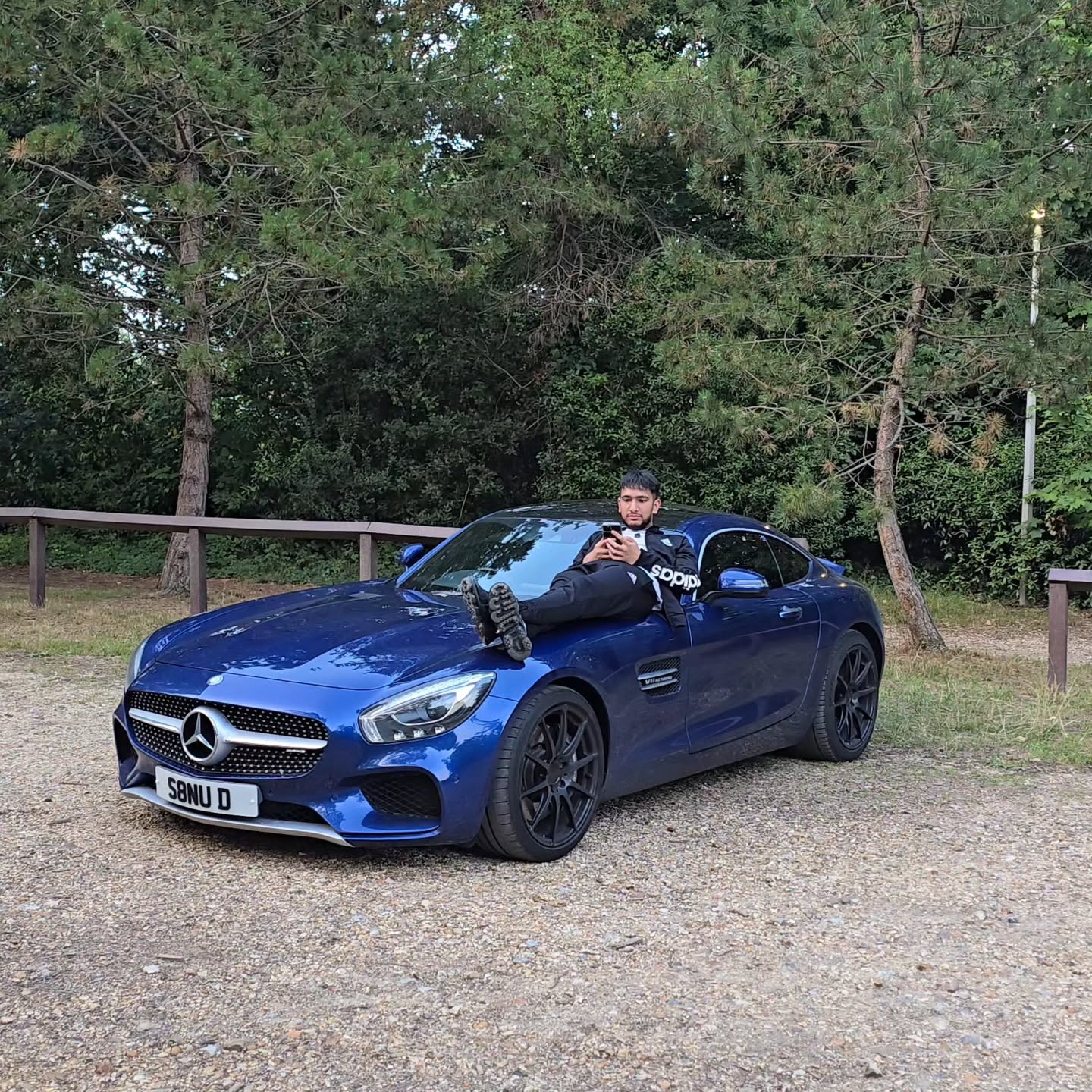 MSD founder beside a blue Mercedes